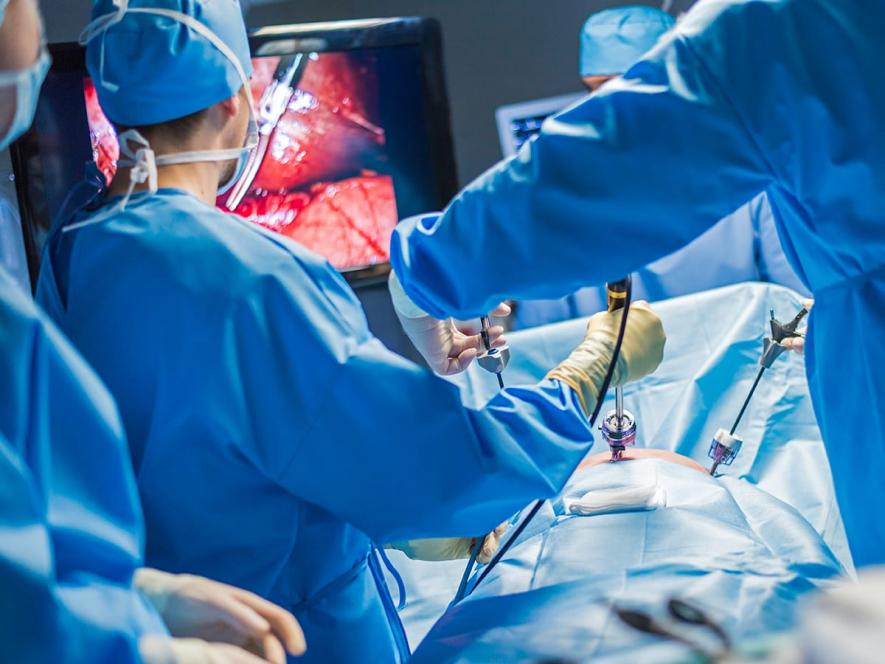 Surgical team performing laparoscopic hernia repair surgery
